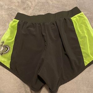 black shorts with green crown detailing